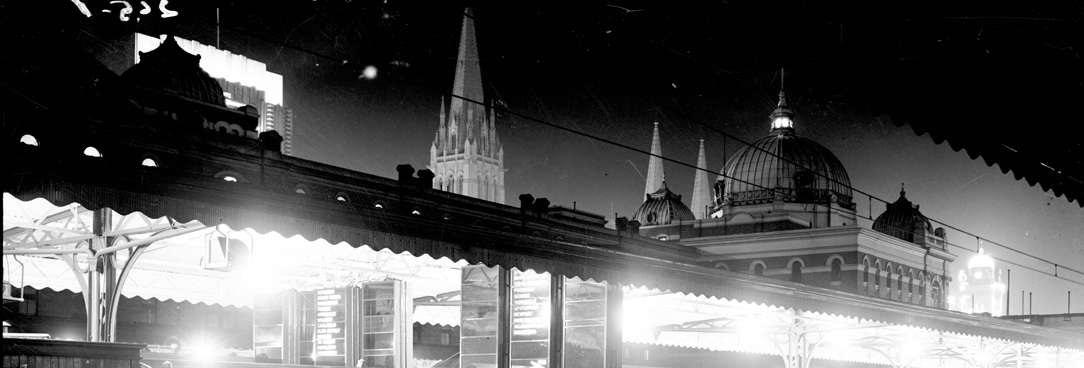 1940s Melbourne VPRS12903 P1 Box265-01 photo of melbourne at night from the view point of a train station platform, the dome of flinders street station can be seen in the distance