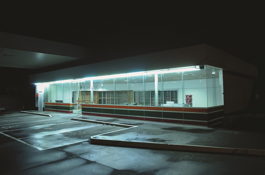 External coloured night image of an abandoned 7 11 store