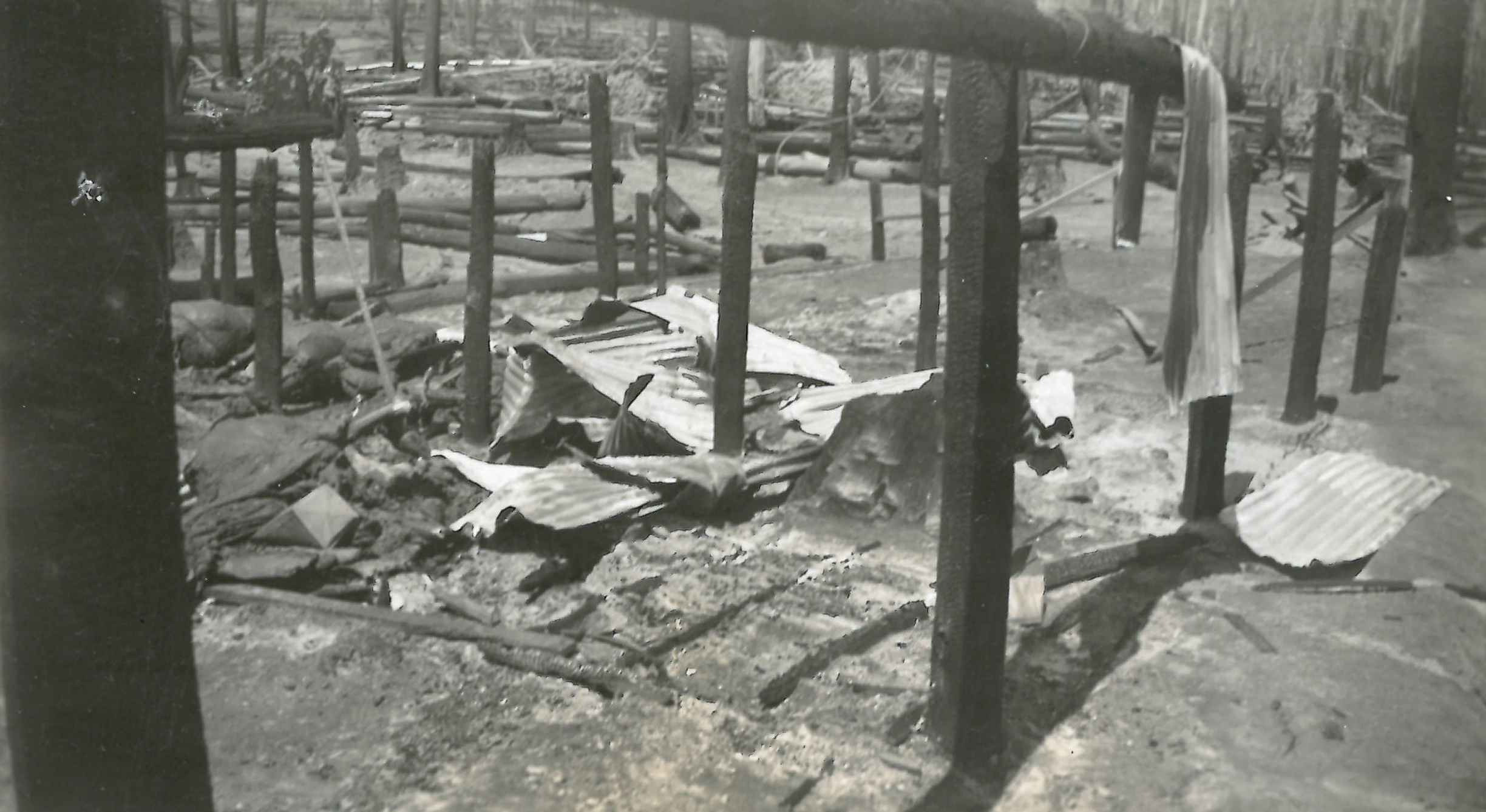 black and white photo of burned down shed