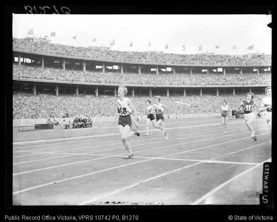 a photo of Betty Cuthbert running around the track