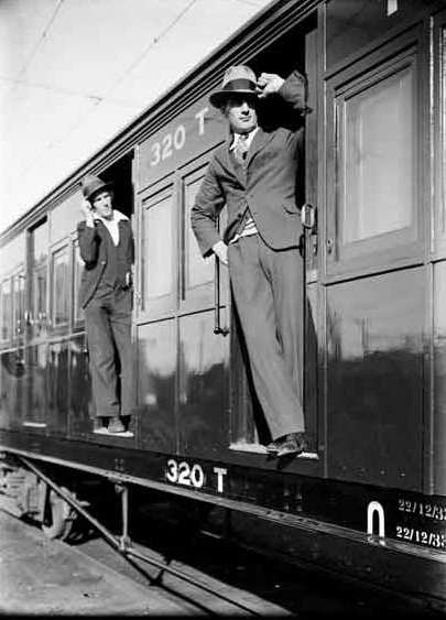 Men Leaning Out of a Train or Tram Carriage 