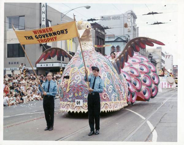 colour float with men carrying a banner in front